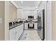 Modern kitchen features stainless steel appliances and white cabinets at 4103 Via Piedra Cir # 10-101, Sarasota, FL 34233