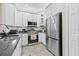 Well-equipped kitchen with stainless appliances, white cabinets, and decorative backsplash at 4103 Via Piedra Cir # 10-101, Sarasota, FL 34233
