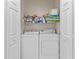 Bright laundry room with a washer and dryer, as well as shelves for additional storage space at 4103 Via Piedra Cir # 10-101, Sarasota, FL 34233