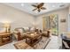Inviting living room featuring neutral tones, ceiling fan, and a sliding glass door at 4103 Via Piedra Cir # 10-101, Sarasota, FL 34233
