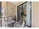 Inviting patio setup with furniture offering a glimpse into the home's interior through sliding glass doors at 4103 Via Piedra Cir # 10-101, Sarasota, FL 34233