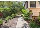 Landscaped walkway leading to the townhome, bordered by manicured bushes and trees at 4103 Via Piedra Cir # 10-101, Sarasota, FL 34233