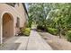 Peaceful side-view of walkway leading to the townhome, enhanced by lush greenery and black fence at 4103 Via Piedra Cir # 10-101, Sarasota, FL 34233