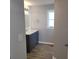 Updated bathroom features a gray vanity with sink, and a window at 4470 Mainlands W Blvd, Pinellas Park, FL 33782