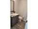 Bathroom features updated vanity and fixtures with modern gray cabinets and gray walls at 4470 Mainlands W Blvd, Pinellas Park, FL 33782