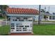 Community sign displaying the pool is open and upcoming community events, located in front of the houses at 4470 Mainlands W Blvd, Pinellas Park, FL 33782