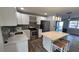 Kitchen featuring stainless steel appliances, a mosaic backsplash, ample counter space, and seating at the island at 4470 Mainlands W Blvd, Pinellas Park, FL 33782