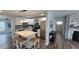 Eat-in kitchen featuring a quartz countertop island, stainless appliances, and modern lighting at 4470 Mainlands W Blvd, Pinellas Park, FL 33782