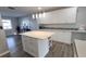 Kitchen features bright white cabinets and an island with white countertop, and stainless steel appliances at 4470 Mainlands W Blvd, Pinellas Park, FL 33782