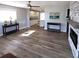Bright living room featuring luxury vinyl plank flooring, modern fireplace, and updated fixtures at 4470 Mainlands W Blvd, Pinellas Park, FL 33782