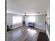 Living room filled with natural light from large windows, complemented by modern gray floors and neutral gray walls at 4470 Mainlands W Blvd, Pinellas Park, FL 33782