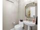 Elegant powder room featuring a pedestal sink, decorative mirror, and neutral wall color at 449 S 12Th St # 1004, Tampa, FL 33602