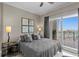 Bright bedroom features a comfortable bed and a sliding glass door to a balcony with a stunning view at 449 S 12Th St # 1004, Tampa, FL 33602