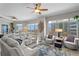 Bright and open living room featuring large windows with city views, a ceiling fan, and modern decor at 449 S 12Th St # 1004, Tampa, FL 33602
