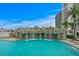 Luxury pool area features a rock waterfall and inviting lounge chairs, set against a backdrop of high-rise buildings at 449 S 12Th St # 1004, Tampa, FL 33602