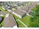Aerial view of the home surrounded by green grass and a white fence in a well-manicured neighborhood at 4918 Wild Senna Blvd, Tampa, FL 33619