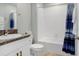 Clean bathroom featuring granite countertops, a shower-tub combination and modern fixtures at 4918 Wild Senna Blvd, Tampa, FL 33619