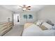 Comfortable bedroom featuring plush carpet, ceiling fan, neutral walls, and dresser storage at 4918 Wild Senna Blvd, Tampa, FL 33619