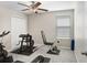 Exercise room with plush carpet, ceiling fan, neutral walls, and exercise equipment at 4918 Wild Senna Blvd, Tampa, FL 33619