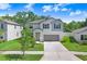 Beautiful two-story house featuring a lush front yard and large driveway at 4918 Wild Senna Blvd, Tampa, FL 33619
