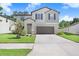 Charming two-story home with a well-maintained lawn and two car garage at 4918 Wild Senna Blvd, Tampa, FL 33619