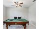 Entertainment room showcasing a classic pool table and a modern ceiling fan at 4918 Wild Senna Blvd, Tampa, FL 33619