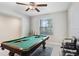 Bright game room featuring a pool table with natural light and a ceiling fan at 4918 Wild Senna Blvd, Tampa, FL 33619