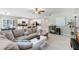 Open-concept living room showcases a modern design, integrating the kitchen with a large comfortable sofa at 4918 Wild Senna Blvd, Tampa, FL 33619