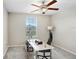 Office with ceiling fan, neutral walls, large window and desk with dual monitors at 4918 Wild Senna Blvd, Tampa, FL 33619