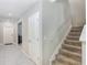 Well-lit stairway with carpeted steps and white railing, adds charm and convenience at 4918 Wild Senna Blvd, Tampa, FL 33619