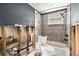 Bathroom featuring a shower with glass block window and a grey color scheme at 4928 Petunia Ct, New Port Richey, FL 34652