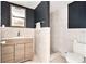 Bathroom featuring tiled walk-in shower, sink, and wood-grained cabinet at 4928 Petunia Ct, New Port Richey, FL 34652