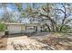 Inviting single-story home featuring mature trees and a well-maintained front yard and attached garage at 4928 Petunia Ct, New Port Richey, FL 34652
