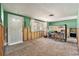 Partially renovated living room featuring tile flooring, a door, and a large window providing lots of natural light at 4928 Petunia Ct, New Port Richey, FL 34652