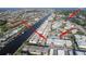 Aerial view of the property located on a waterway, showcasing the building, pool, and surrounding neighborhood near the beach at 5111 Amulet Dr # 208, New Port Richey, FL 34652