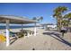 Sunny beach featuring picnic tables and palm trees, providing an ideal spot for outdoor gatherings and relaxation at 5111 Amulet Dr # 208, New Port Richey, FL 34652