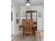 Traditional dining room with wooden table, chairs, china cabinet, and decorative mirror, creating a cozy ambiance at 5111 Amulet Dr # 208, New Port Richey, FL 34652