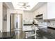 Well-lit kitchen boasts stainless steel refrigerator and white cabinets, complemented by sleek countertops and modern fixtures at 5111 Amulet Dr # 208, New Port Richey, FL 34652