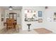 Open-concept design showing dining area and kitchen with white cabinets, stainless steel appliances, and eat-in bar at 5111 Amulet Dr # 208, New Port Richey, FL 34652