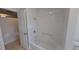 Bathroom featuring a shower over tub, new tiling and an inset storage shelf at 5337 11Th N Ave, St Petersburg, FL 33710