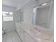 Bright bathroom featuring double sinks, marble countertops, and tiled floors at 5337 11Th N Ave, St Petersburg, FL 33710