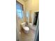 Compact bathroom featuring a toilet, vanity with mirror, and a patterned floor at 5337 11Th N Ave, St Petersburg, FL 33710