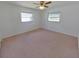 A carpeted bedroom with a ceiling fan and two windows at 5337 11Th N Ave, St Petersburg, FL 33710