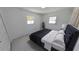 Bedroom featuring a dark bed frame, two windows and a light colored paint at 5337 11Th N Ave, St Petersburg, FL 33710