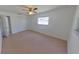 This carpeted bedroom features a ceiling fan, closet, and bright window at 5337 11Th N Ave, St Petersburg, FL 33710