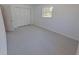 The carpeted bedroom features a large closet with sliding doors and a bright window at 5337 11Th N Ave, St Petersburg, FL 33710