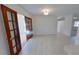 A dining room boasts tile flooring, french doors, and access to the kitchen at 5337 11Th N Ave, St Petersburg, FL 33710