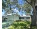 Well-maintained single-story home featuring a manicured lawn, an attached garage, and lush landscaping at 5337 11Th N Ave, St Petersburg, FL 33710