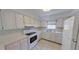 This well-lit kitchen features white appliances, bright cabinets, and tile backsplash at 5337 11Th N Ave, St Petersburg, FL 33710