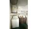 Functional laundry room with washer, utility sink, and storage shelves for convenience at 5337 11Th N Ave, St Petersburg, FL 33710